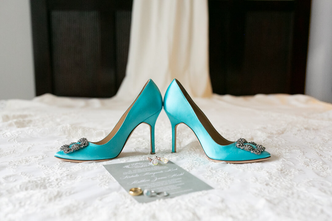 Details of a bride's teal shoes and jewelry